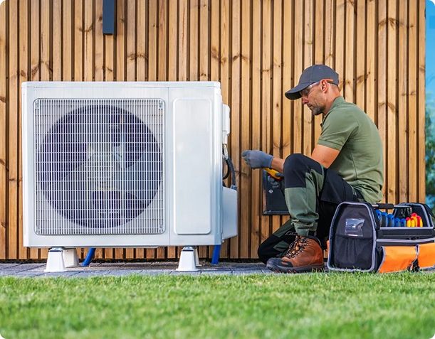 Technician repairing outdoor air conditioning unit