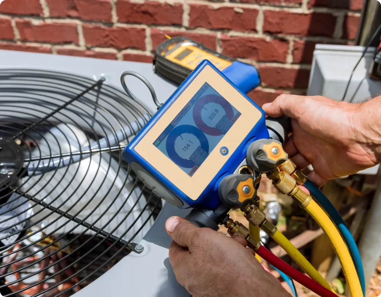 Hands adjusting air conditioning gauges